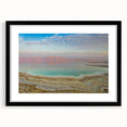 Colorful abstract art print of the Dead Sea in vibrant blues and oranges, framed in black, ideal for living room decor.