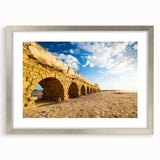 Textured abstract art print depicting a Middle Eastern scenery in muted earth tones, framed in silver, ideal for bedroom art.