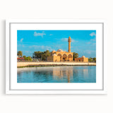 Abstract art print of a Middle Eastern landscape in muted earth tones on a framed white mat, ideal for dining room decor.