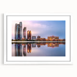 Abstract art print of Abu Dhabi skyline in muted earth tones on a framed white mat, suitable for dining room decor.