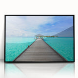 Large abstract wall art depicting the serene Bora Bora landscape in muted blue and green tones, framed in black acrylic.