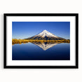 Abstract art print of Mt. Taranaki in vibrant, textured colors on a large black-framed canvas, ideal for living room decor.