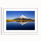 Abstract art print of Taranaki in New Zealand, showcasing vibrant green and blue tones on a white-framed canvas.