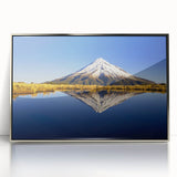 Mid-century modernist art of Mount Taranaki in muted earth tones on a silver-framed acrylic print.