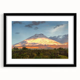 Colorful abstract art print of a South American scenery in a large black frame, ideal for living room decor.