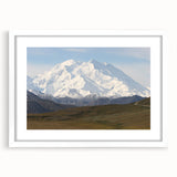 Abstract art print depicting Denali, Alaska in muted earth tones on a framed white mat, suitable for dining room decor.