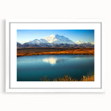 Abstract art print of Alaskan scenery in muted earth tones on a framed white mat, ideal for dining room decor.