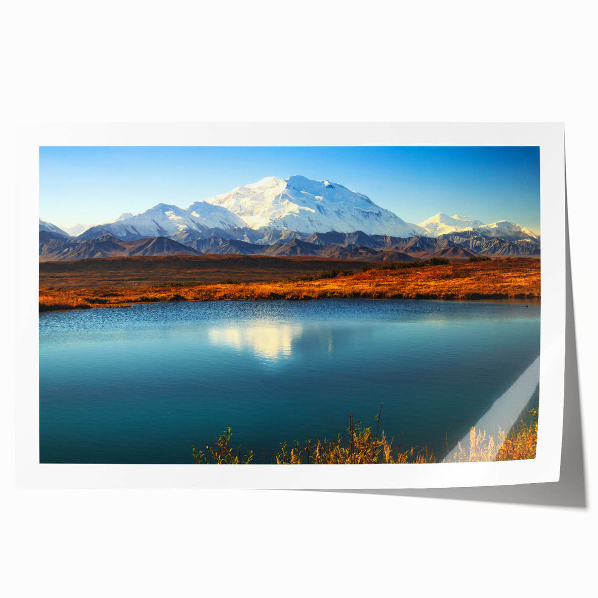Alaskan landscape with floral elements in soft blue and green tones on a rolled canvas.