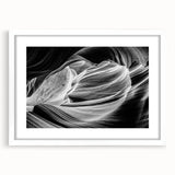 Abstract art print of Antelope Canyon in Arizona with vibrant red and orange tones on a framed white mat.
