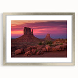 Textured art depicting Monument Valley in muted earth tones on a framed silver mat, suitable for bedroom art.
