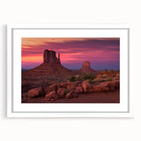 Abstract art print of Monument Valley in Arizona, featuring earthy red and orange tones on a white framed canvas.