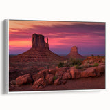 Vintage poster art of Monument Valley in vibrant red and orange tones on a white-framed canvas.