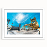 Abstract art print of Sacramento skyline in muted blue and gray tones on a white framed mat, suitable for dining room decor.