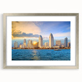 Textured art print of abstract San Diego scenery in muted blues and grays, framed in silver, suitable for bedroom decor.