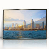 Mid-century modernist art depicting the San Diego skyline in muted blue tones, framed in silver acrylic.