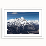 Abstract art print of Vail, Colorado in cool blue and white tones, framed with a white mat, suitable for dining room decor.