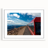 Abstract art print of Pikes Peak in muted earth tones, framed in white, ideal for bedroom or dining room decor.