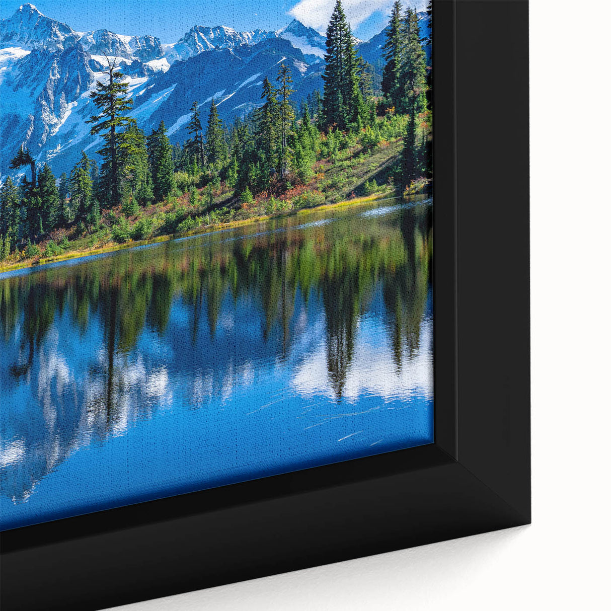 Close-up of a black framed canvas featuring a textured, colorful depiction of the Rocky Mountains.
