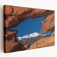 Side view of a large stretched canvas featuring a detailed Colorado Springs landscape in natural earth tones.