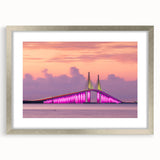 Textured art print of abstract Tampa skyline in muted blue and gray tones, framed in silver, ideal for bedroom wall decor.