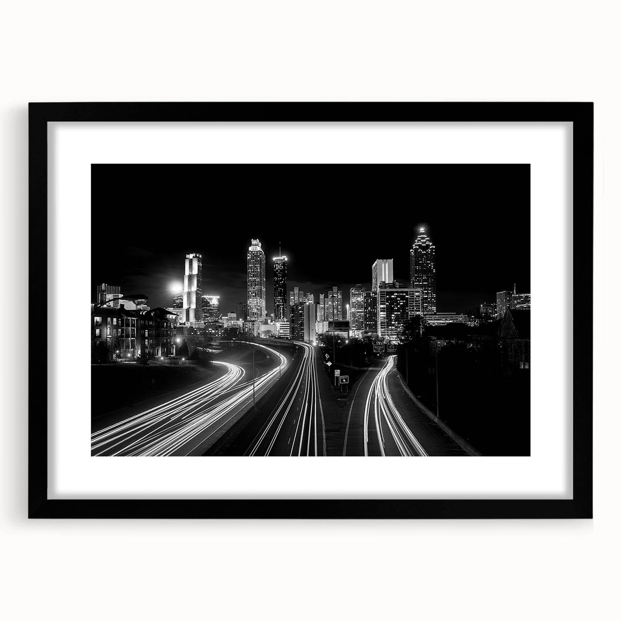 Abstract art print of Atlanta skyline in vibrant colors on a large framed canvas, suitable for living room decor.