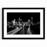 Abstract art print of Atlanta skyline in vibrant colors on a large framed canvas, suitable for living room decor.
