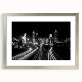 Textured abstract art print of Atlanta skyline in muted gray and blue tones on a framed silver canvas.
