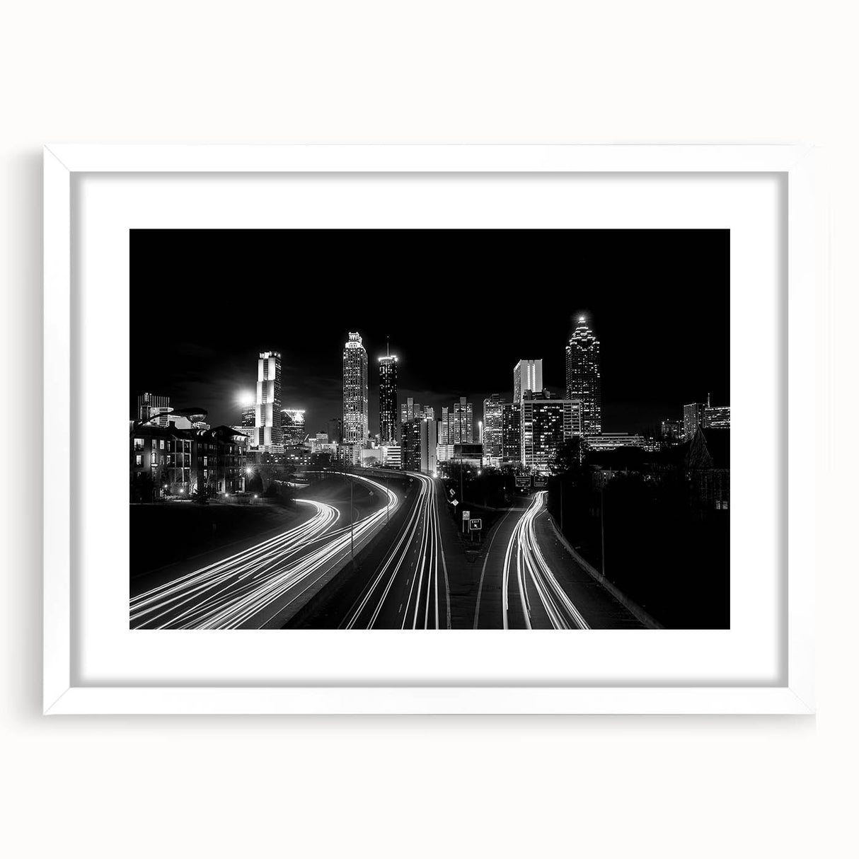 Abstract art print of Atlanta skyline in monochrome shades on a white framed canvas, suitable for dining room decor.