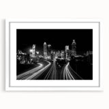 Abstract art print of Atlanta skyline in monochrome shades on a white framed canvas, suitable for dining room decor.