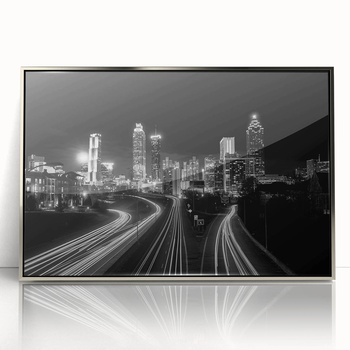 Mid-century modernist art depicting the Atlanta skyline in muted gray and blue tones on a framed acrylic print.