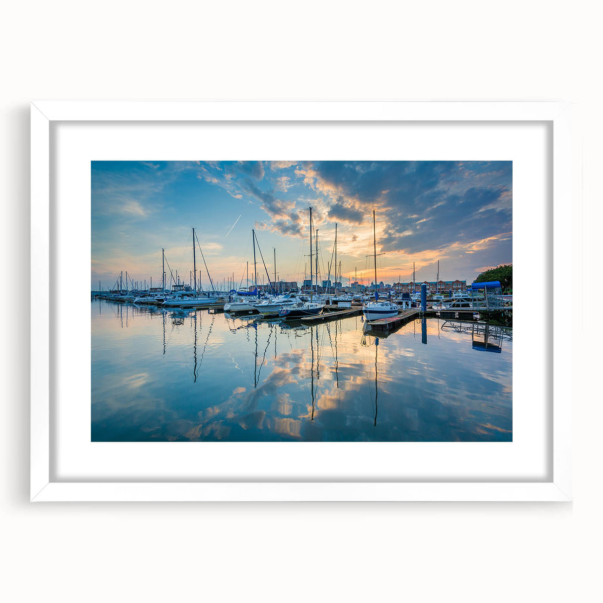 Abstract art print of Baltimore skyline in muted blue and gray tones on a white framed poster.