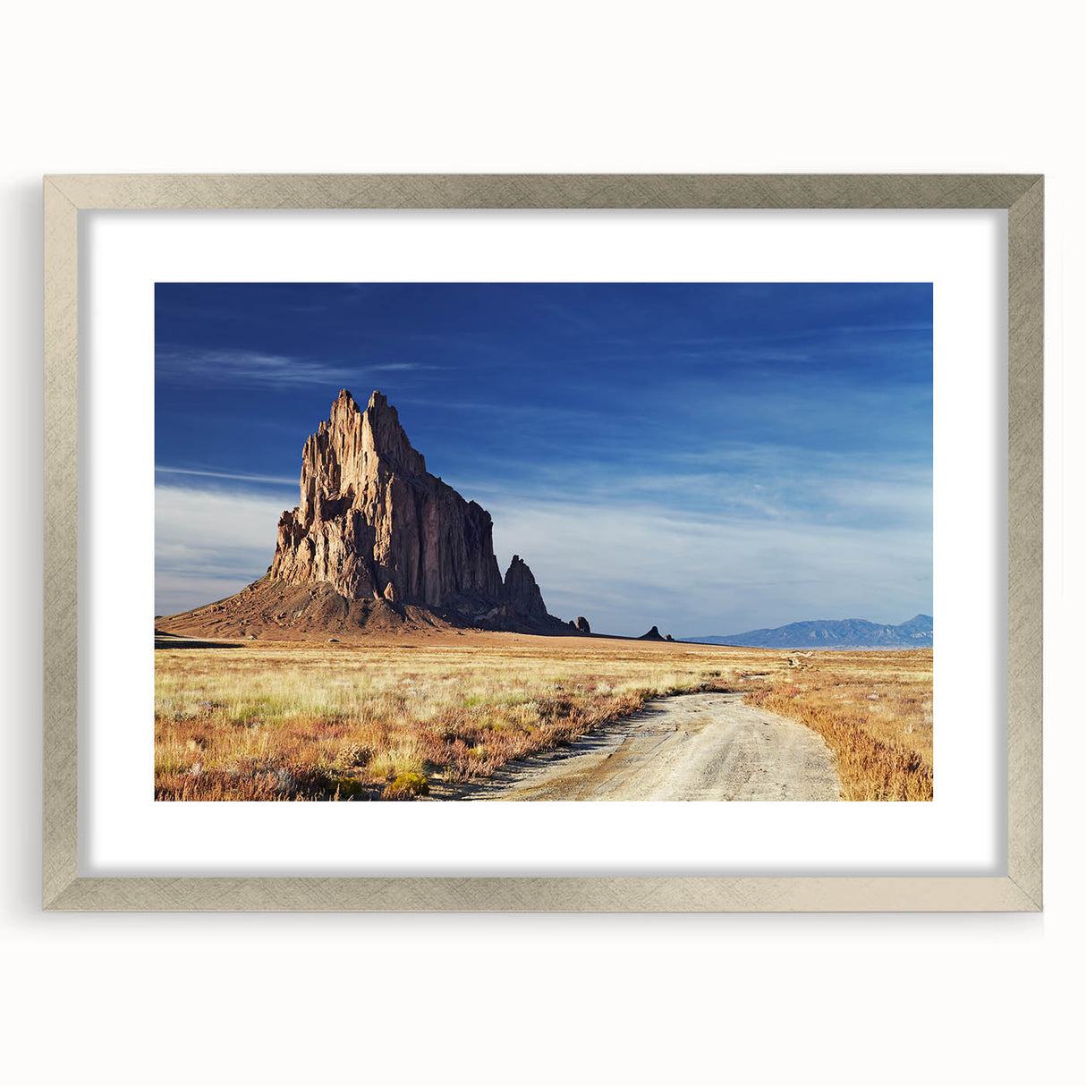 Textured abstract art print of New Mexico scenery in muted earth tones, framed in silver, ideal for bedroom art.