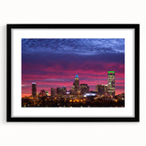 Extra large abstract art print of Charlotte skyline in vibrant colors on a textured canvas, framed in black.