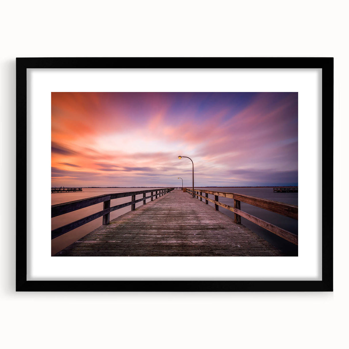 Abstract art print of colorful, textured scenery, in a black frame, ideal for living room decor.