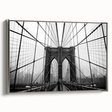 Framed canvas of the Brooklyn Bridge in a vintage poster style with a black and colorful palette, suitable for office decor.
