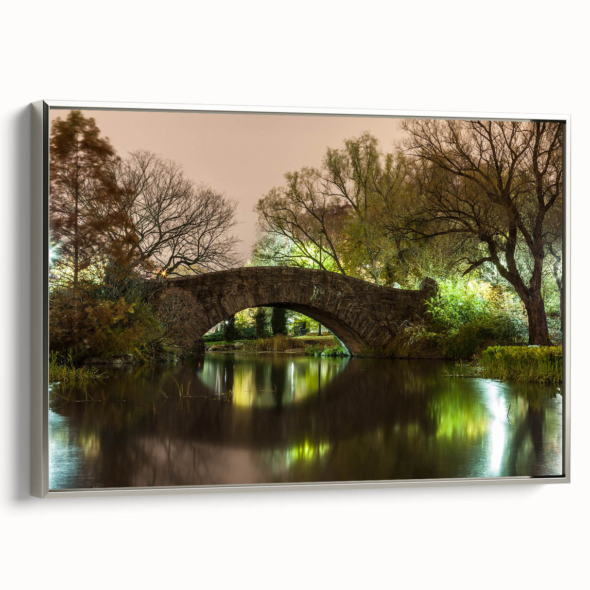 Framed canvas depicting a vintage-style landscape painting of Central Park in muted greens and browns.
