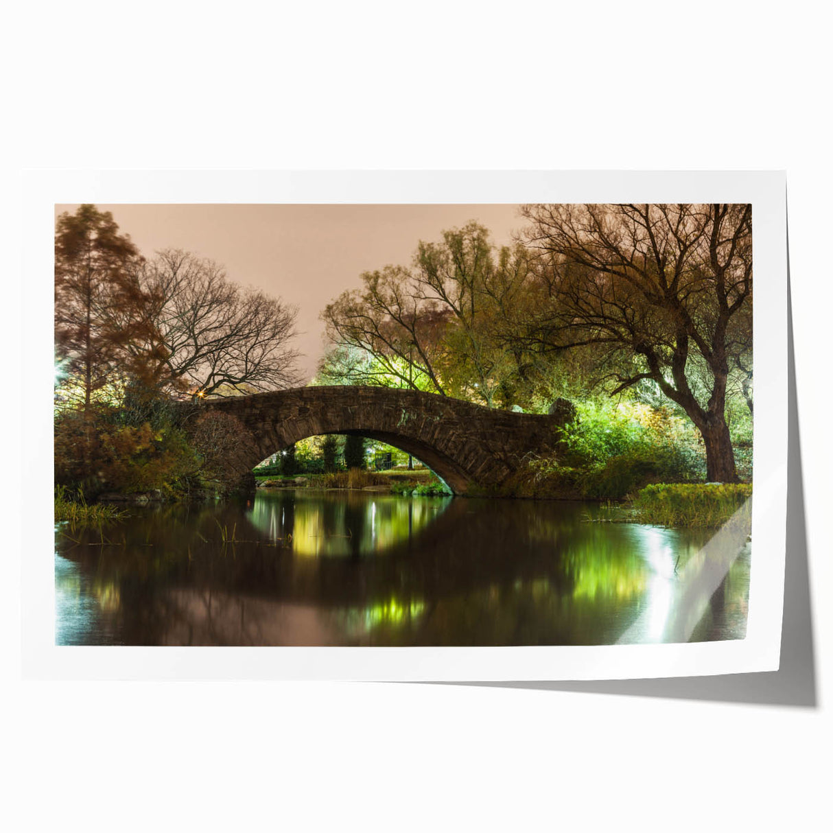 Rolled print of Central Park with lush greenery and a skyline backdrop, in muted green and blue tones.
