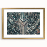 Extra large abstract art print of NYC skyline in muted gray and gold tones on a framed canvas, ideal for living room decor.