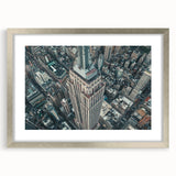 Abstract textured art print of NYC skyline in muted gray tones on a framed silver mat, ideal for modern bedroom decor.