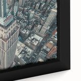 Extra large framed canvas featuring a textured depiction of NYC's Empire State Building in black with colorful accents.