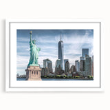 Abstract art print of the Statue of Liberty in muted green and blue tones on a white framed canvas.