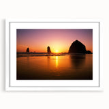 Abstract art print of Cannon Beach, Oregon, in muted gray and blue tones on a framed white mat.