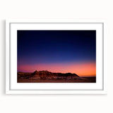 Abstract art print of South Dakota Badlands in muted earth tones on a framed white mat, suitable for dining room decor.