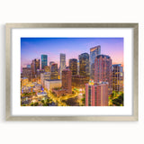 Textured art print of abstract Houston skyline in muted gray tones on a silver-framed mat, suitable for bedroom decor.