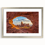 Textured art print of Arches National Park in muted earth tones on a framed canvas, suitable for bedroom decor.