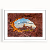 Abstract art print of Arches National Park in muted earth tones, framed with a white mat, suitable for dining room decor.