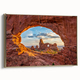 Framed canvas landscape art depicting Arches National Park in Utah with a vintage-style gold frame, ideal for bedroom decor.