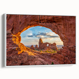Vintage poster art of Arches National Park on a framed canvas, featuring vibrant red and orange tones.