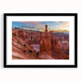 Extra large abstract art print of Bryce Canyon in vibrant red and orange tones, displayed in a black frame with mat.