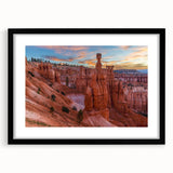 Extra large abstract art print of Bryce Canyon in vibrant red and orange tones, displayed in a black frame with mat.